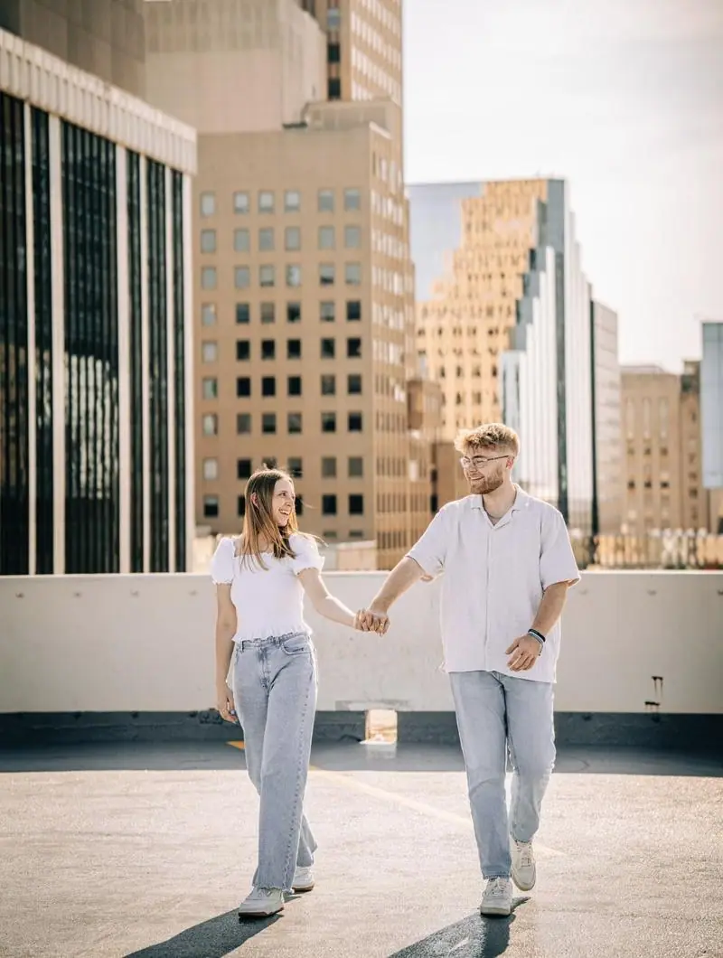 Couple holding hands downtown rooftop engagement photography Tulsa Oklahoma