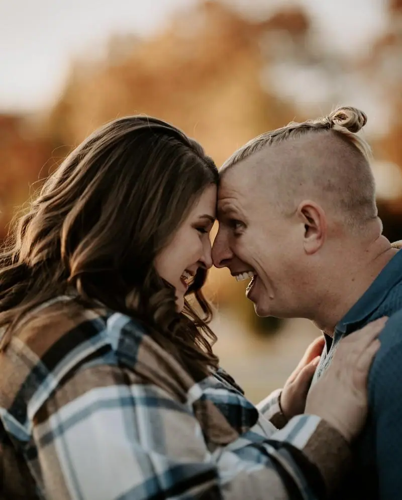 Couple laughing foreheads together fall engagement session Oklahoma